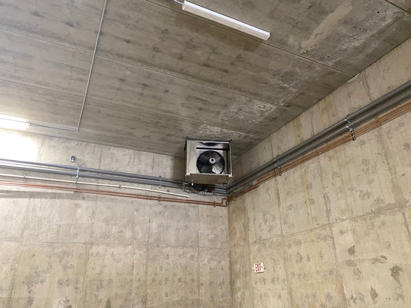 Fan coil unit mounted in a concrete-walled cold room