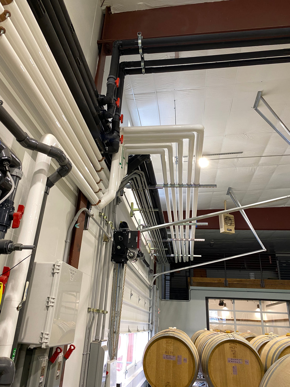 Glycol lines routed through a barrel room