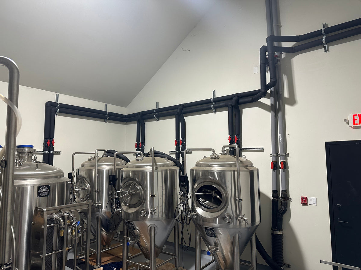 Technician inspecting brewery equipment